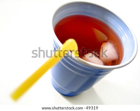 Focus on the drink/cubes, a blue cup with red fruit drink and yellow straw.