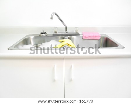 A kitchen sink with cleaning supplies.