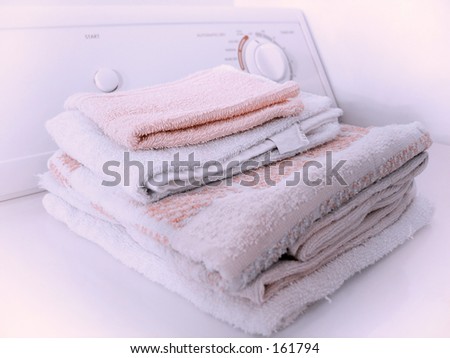 Stack of towels on the dryer.