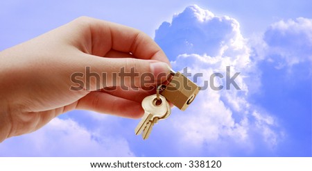 Hand holding lock and keys - cloudy sky background