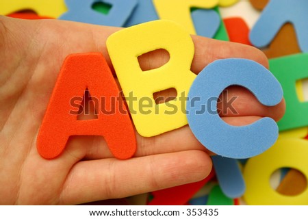 hand holding foam letters  