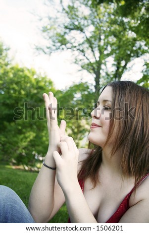 Woman looking at bug crawling on her hand