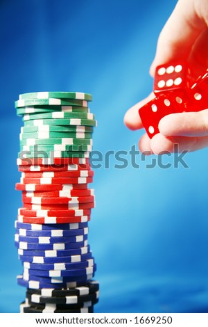 A stack of poker playing chips and rolling die