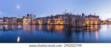 The Hague (Den Haag) skyline panorama with Mauritshuis Museum, Binnenhof palace (Dutch Parliament), and modern skyscrapers reflected in the Hofvijver canal at twilight, The Netherlands.