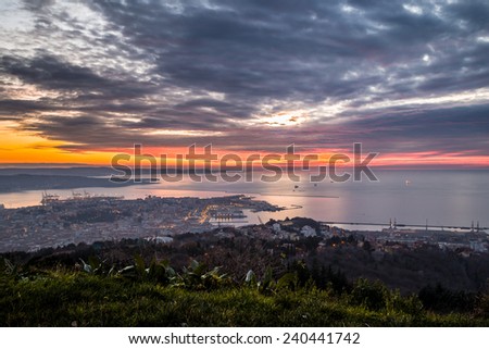 the sun goes down in the bay of Trieste, Italy
