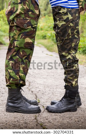 man woman couple feet in military boots