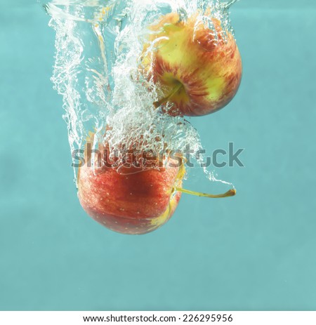 Bright red apple and water splash. Tasty and healthy food