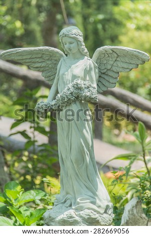 A female sculpture in a serene garden