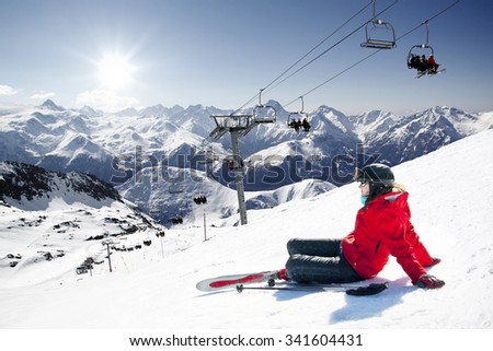 Girl skier lying on snow with ski,  French Alps High mountain