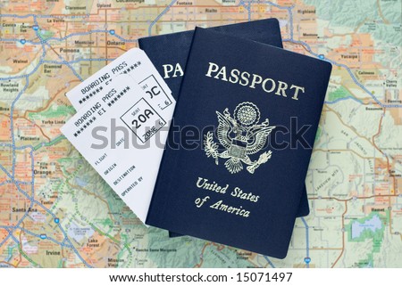 Two airplane boarding passes and two American passports, over map, selective focus