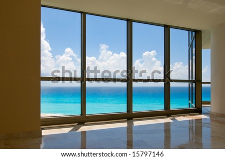 View of tropical beach through hotel windows