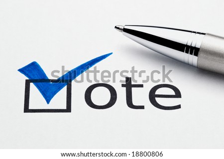 Blue checkmark on vote checkbox, pen lying on ballot paper. Concept for voter registration and participation in elections, or for voting blue/democrat; not an isolation, paper texture is visible