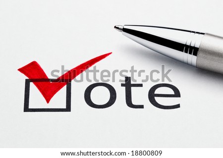 Red checkmark on vote checkbox, pen lying on ballot paper. Concept for voter registration and participation in elections, or for voting red/republican; not an isolation, paper texture is visible