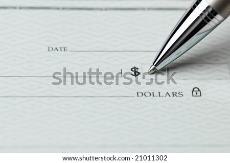 Closeup of ballpoint pen writing on a blank bank check, ready to fill in the dollar amount; selective focus on the tip of the pen