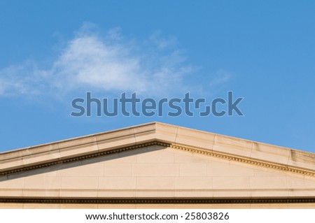 Detail of neoclassical building showing cornice and freeze, under warm sunset light, with lots of copy space
