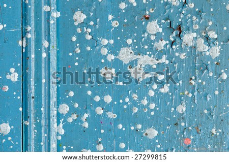 Detail of decaying wood door with paint drops