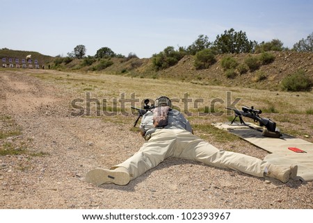 Shooter on the ground taking a shot at a distant target