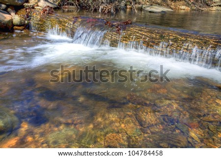 Water spilling over the top of a large log on the Blue Ridge of Virginia