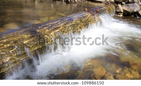 Water spilling over a large log on the Blue Ridge of Virginia