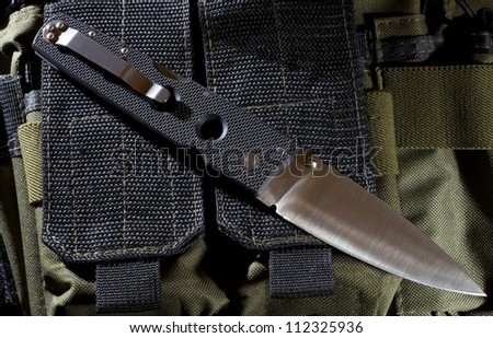 Knife that is on a nylon ruck sack in the night