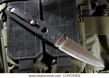 Tactical folding knife that is on nylon gear