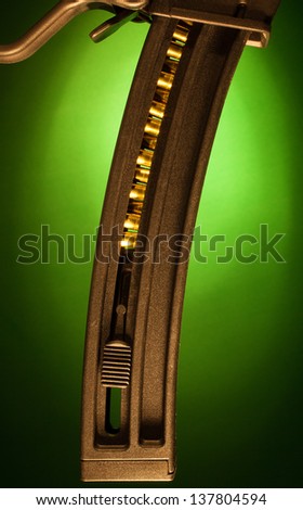 High capacity assault rifle magazine with a green background