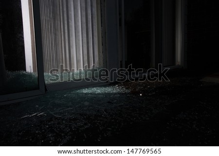 Broken sliding glass door at night use in a burglary