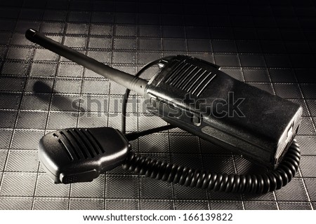 Two way radio in the dark along with its microphone