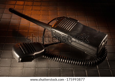 Two way radio and microphone with an orange light above