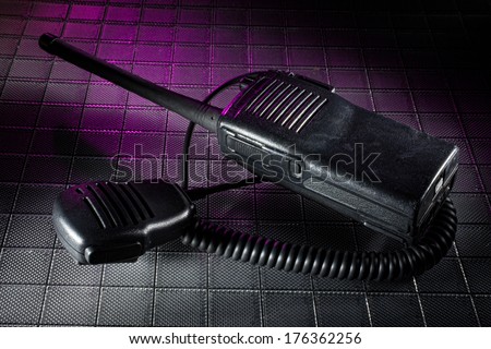 Handheld two way radio with purple gel and microphone