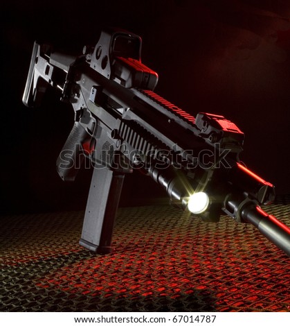 Assault rifle that is on netting with red back lighting