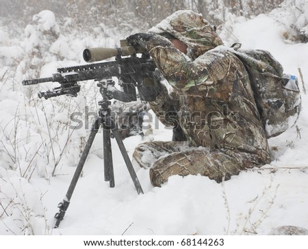 Hunter that is trying to sight in during a winter blizzard