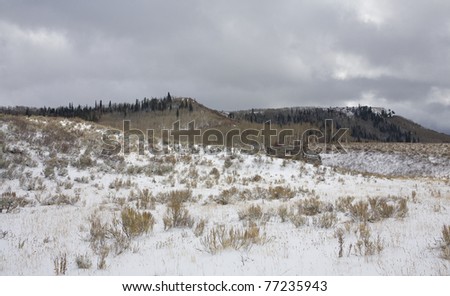 Early settlers cabin ruins that are covered with winters first snow