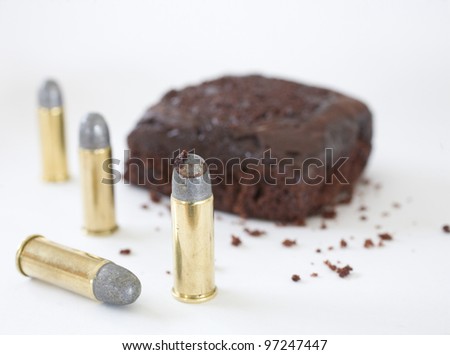 Bullets and ammunition that has chocolate cake frosting on it