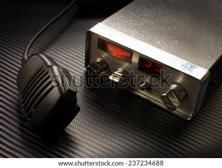 two way radio and microphone on a graphite sheet background