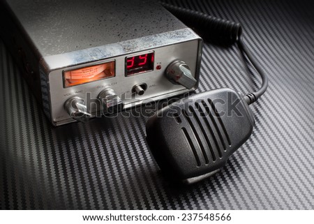 Two way radio with microphone on a gray background