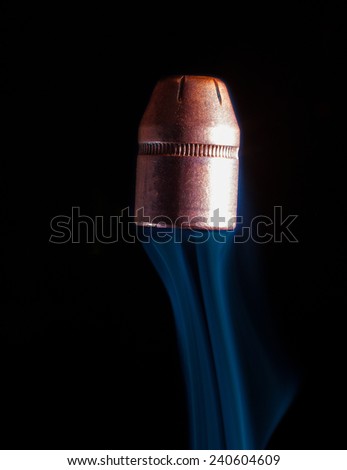 Pistol bullet heading skyward with a smoke trail behind