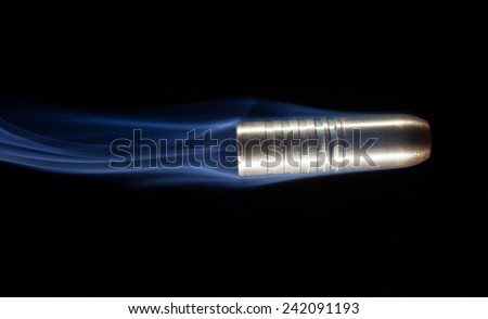 Copper bullet with bands that has smoke coming from behind
