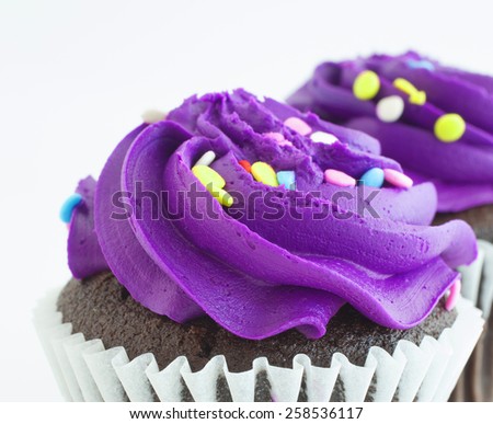 Thick and sweet purple frosting on cupcakes