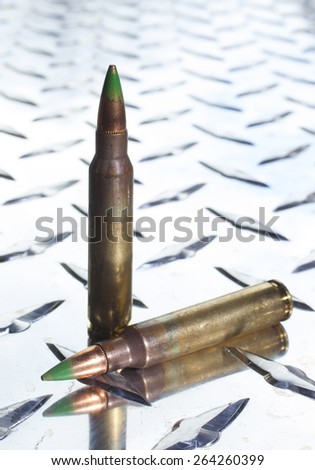 Rifle cartridges with bullets that have steel tips on a chrome plate