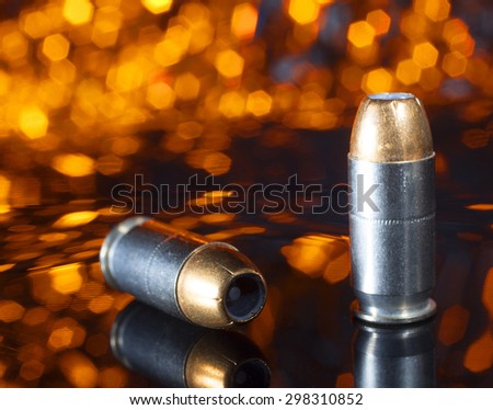 Ammunition designed for a pistol that has a hollow pointed bullet with an orange background