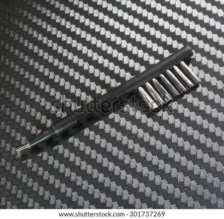 Small brush used to clean electronics on a graphite background