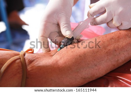 Doctor drawing blood sample from arm for blood test,Doctor drawing blood sample from hand