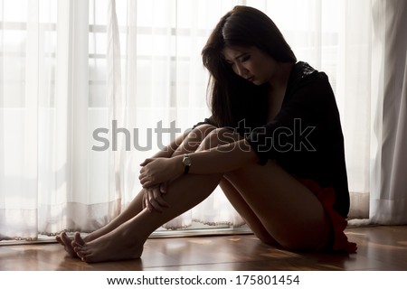Young  woman sad  sitting on floor