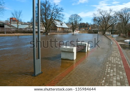 Urban river embankment submerged by flood