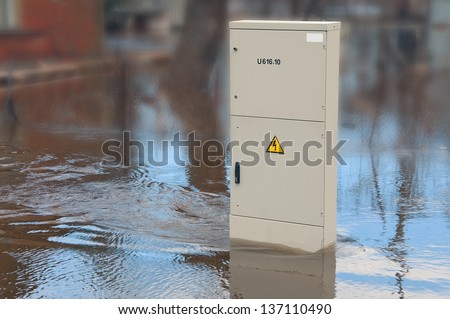 Dangerously swollen river flooded electrical cabinet