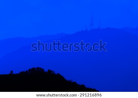 Mountain Hilly Background with Communication Tower.Dark Blue