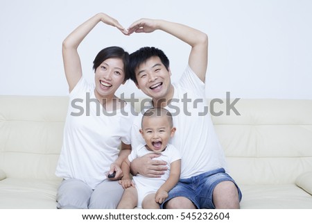 Happy Chinese family sitting in sofa, Beijing,China
