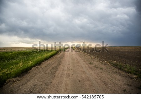Storm clouds with a dirt road in rural America