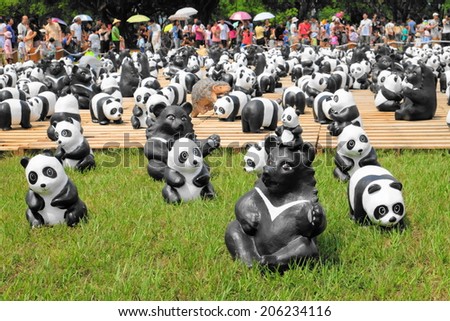 Nantou, Taiwan - July 20,2014: 1600 Pandas World Tour in  Chung-hsing New Village, Taiwan. Part of pandas world tour are designed by French artist Paolo Grangeon. Some pandas wear Taiwan bamboo hats.